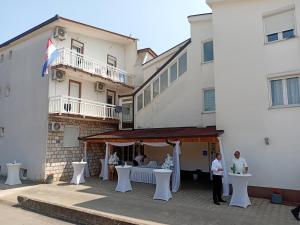 a group of people standing in front of a building at Apartman Zemo camp in Međugorje