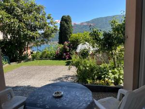 a blue table and chairs on a patio with a view at Casa Balwin in Ponte Tresa