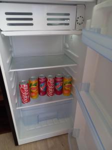 an open refrigerator with cans of cocacola in it at Aux amoureux de Provence in Fox-Amphoux