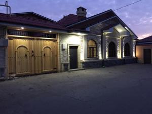 a house with a gate and a driveway at Xan boutique hotel in Sheki