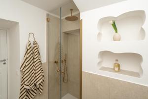 a bathroom with a shower and a glass door at Casanova Suite in Positano +13 photos
