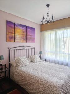 une chambre avec un grand lit et une fenêtre dans l'établissement Playa y relax, à Górliz-Elexalde 21 autres photos