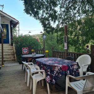 a table and chairs sitting on a wooden deck at CAMPING Pleine Nature in Boule - dÊ¼Amont +15 photos