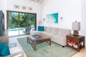 a living room with a couch and a table at Pristine Bay 1316 home in Roatan