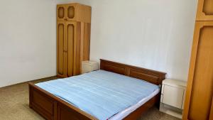 a small bedroom with a bed and a cabinet at Adria spa Rafailovici in Bečići