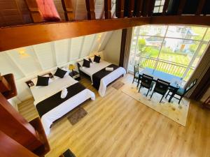 an overhead view of a room with two beds and a table at Meridian Haven in Nuwara Eliya