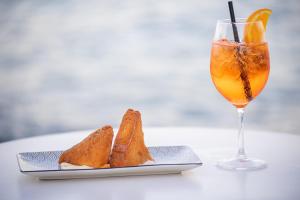 a plate of bread next to a glass of orange juice at Pagoda Lifestyle Hotel in Ischia