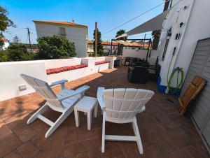 a pair of chairs and a table on a patio at Casa Velha de Vila Nova in Vila Nova de Milfontes +38 photos
