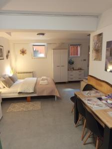 a bedroom with a bed and a table in it at Mieszkanie do wynajęcia w Centrum in Olecko +7 photos