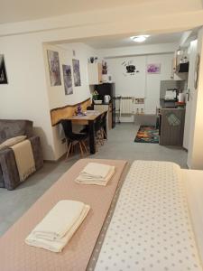 a living room with a bed and a table with two towels at Mieszkanie do wynajęcia w Centrum in Olecko
