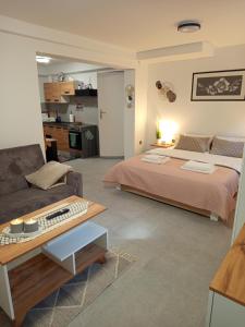 a bedroom with a large bed and a couch at Mieszkanie do wynajęcia w Centrum in Olecko