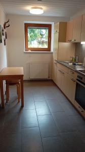 a kitchen with a table and a table and a window at FEWO "Unterm Wald" in Stumm +39 photos
