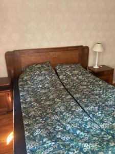 a bed in a bedroom with a floral bedspread at "Maroli House" in Vrŭv