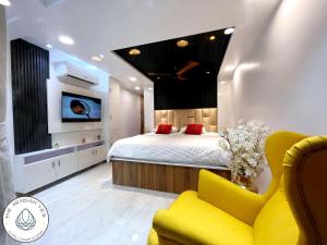 ein Schlafzimmer mit Bett, Fernseher und Sofa in der Unterkunft THE ARABiAN VIEW in Pālghar