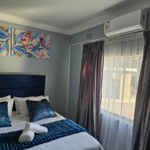 a bedroom with a bed and a window with a air conditioner at Cosy Villa in Stegi +44 photos