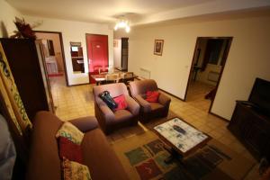 a living room with two couches and a table at La Roseraie gîte 3 épis avec piscine in Ruoms