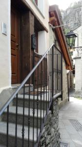 a staircase leading to a building with a wooden door at Appartamenti Paquier in Valtournenche