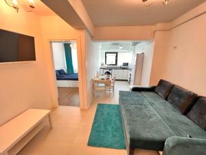 a living room with a couch and a table at Central Metropolitan Bright 2 in Iaşi