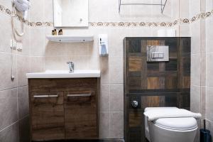a bathroom with a sink and a toilet at Mauna Hotel in Bozcaada +22 photos