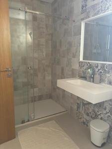 a bathroom with a shower and a sink and a toilet at Colina Smir in Marina Smir