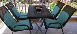 a table with chairs and drinks on a patio at ΑLEXANDRAS HOUSE in Preveza