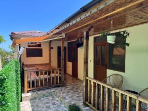 a porch of a house with a wooden deck at Вила Рея in Sinemorets +8 photos