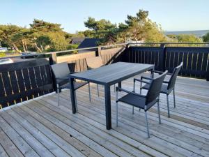 a table and chairs sitting on a deck at strand huset in Halmstad