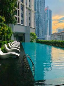 a swimming pool in a city with tall buildings at KLCC The Mews Luxury suites Malaysia in Kuala Lumpur