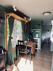 a kitchen with a table and chairs in a room at Tinyhouse in Stora Skedvi
