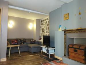 a living room with a couch and a fireplace at Maison cévenole Alzon in Alzon