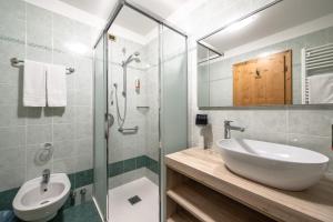 a bathroom with a sink and a glass shower at EL CIASEL in Canazei +19 photos