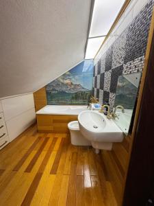 a bathroom with a sink and a tub and a toilet at Lola's Apartment in Arad