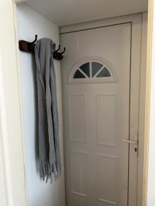 a pair of mittens hanging next to a door at Beautiful studio near the city center in Talence