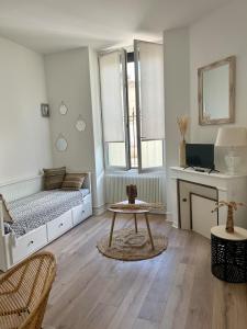 a room with a bed and a table in it at Beautiful studio near the city center in Talence