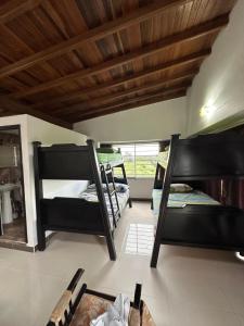 a room with three bunk beds in a room at Casa en Marinilla cerca a guatape y el peñol in Marinilla +2 photos