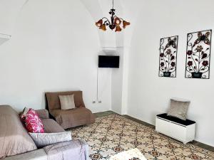 a living room with a couch and a chair at Gioem in Botrugno