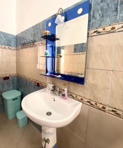 a bathroom with a sink and a mirror at At-Salaj1 in Vlorë