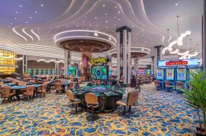 a casino on a cruise ship with tables and machines at GRAND SAPPHIRE HOTEL CASINO and RESIDENTS 1 Bedroom Suit with Superior Sea View and Free Internet in Áyios Yeórgios