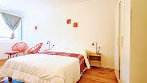 a bedroom with a bed and a desk and a window at PARCHEGGIO GRATUITO ZONA OSPEDALE panoramico, tranquillo, nel verde in Trento