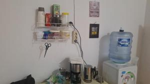a bottle of water sitting on top of a blender at 88HappyHomestay in Luwuk