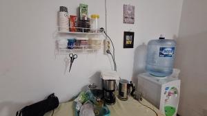 a bottle of water sitting on top of a microwave at 88HappyHomestay in Luwuk