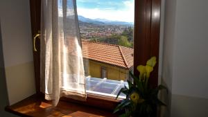 a window with a view of a building at Il Giardino di Berbech Città Alta in Bergamo