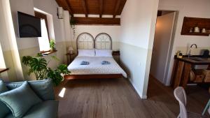 a bedroom with a bed and a couch at Il Giardino di Berbech Città Alta in Bergamo +23 photos