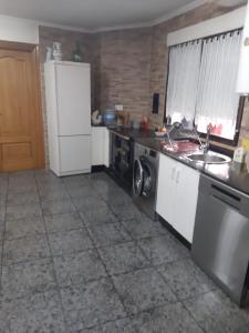 a kitchen with a stove and a sink and a refrigerator at Medulillas de Yeres in Yeres