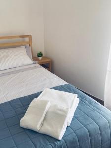 a bed with two towels sitting on top of it at Casa São Pedro by Portus Alacer in Sousel