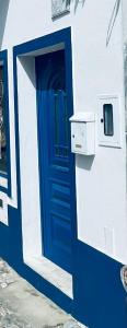 a blue door on the side of a building at Casa São Pedro by Portus Alacer in Sousel