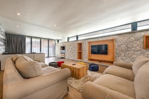 a living room with two couches and a tv at 48 On Possession Island in Swakopmund