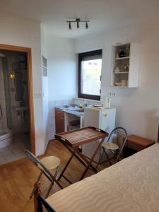 a kitchen with a table and chairs in a room at Apartments Sopaljska 24a in Crikvenica