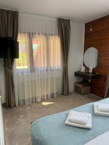 A bed or beds in a room at MB Hotel