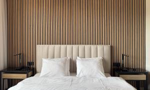 a bedroom with a large bed with two night stands at Lakefront Bled - Rooms & Apartments in Bled